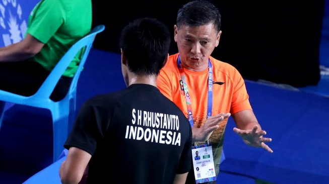 Pelatih Tunggal Putra Pelatnas PBSI, Hendry Saputra (kanan), memberikan arahan kepada anak asuhnya, Shesar Hiren Rhustavito, saat menghadapi Loh Kean Yew (Singapura) di babak perempat final SEA Games 2019, Sabtu (7/12). [Humas PBSI]