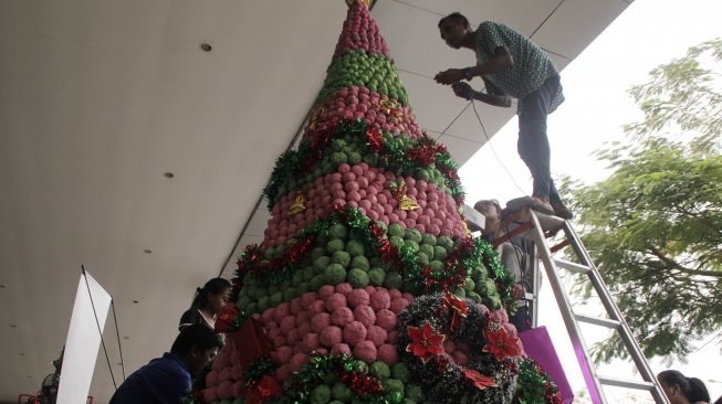 Sejumlah pemuda sedang membuat dan menghias pohon Natal yang terbuat dari kertas-kertas bekas saat mengikuti lomba menghias pohon Natal di Kupang, NTT, Sabtu (14/12). [ANTARA FOTO/Kornelis Kaha]