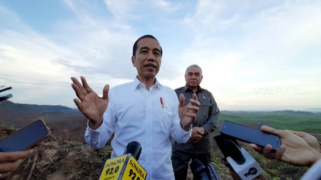 Presiden Joko Widodo (kiri) berbincang dengan Gubernur Kalimantan Timur Isran Noor (kanan) saat meninjau lokasi rencana ibu kota baru di Sepaku, Penajam Paser Utara, Kalimantan Timur, Selasa (17/12). [Suara.com/Ummy Hadyah Saleh]