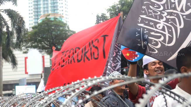 Sejumlah massa yang tergabung dari berbagai organisasi masyarakat (ormas) melakukan aksi bela Uighur di depan Kedutaan Besar Republik Rakyat China, Kuningan, Jakarta Selatan, Jumat (27/12). [Suara.com/Alfian Winanto]