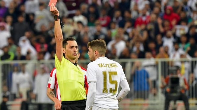 Gelandang Real Madrid, Federico Valverde (kanan) diganjar kartu merah pada laga Piala Super Spanyol 2020 kontra Atletico Madrid di King Abdullah Sports City, Jeddah, Arab Saudi, Senin (13/1/2020) dini hari WIB. [Giuseppe CACACE / AFP]