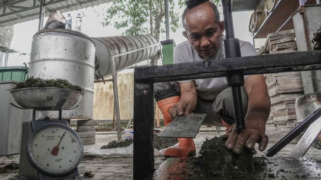 Dosen Poltekes Kemenkes Semarang, Djamaluddin Ramlan, melakukan proses pengolahan sampah organik menjadi batu bata dan paving blok di Poltekes Semarang Kampus Baturraden, Banyumas, Jateng, Selasa (14/01). [ANTARA FOTO/Idhad Zakaria]
