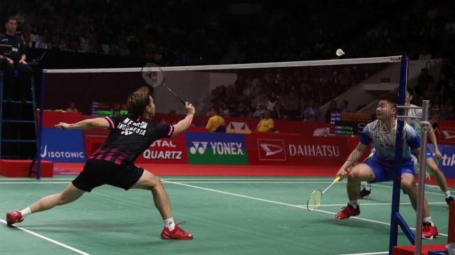 Pasangan Ganda Putra Indonesia Marcus Fernaldi Gideon dan Kevin Sanjaya Sukamuljo mengembalikkan kok kearah Pasangan Ganda China He Ji Ting dan Tan Qiang dalam babak kedua Daihatsu Indonesia Masters 2020 di Istora Senayan, Jakarta, Kamis (16/1). [Suara.com/Angga Budhiyanto]