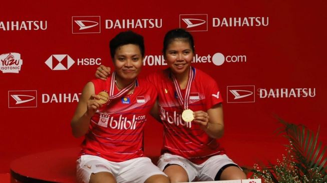 Pebulu tangkis ganda putri Indonesia Apriyani Rahayu dan Greysia Polii (kanan) memegang medali usai menjuarai kejuaraan Daihatsu Indonesia Masters 2020 kategori ganda putri di Istora Senayan, Jakarta, Minggu (19/1). [Suara.com/Alfian Winanto]