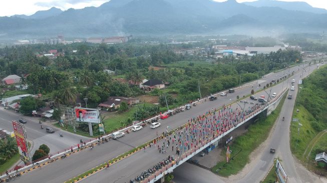 Warga mengikuti kegiatan senam di Fly Over Bandara Internasional Minangkabau (BIM), di Padangpariaman, Sumatera Barat, Minggu (2/2). [ANTARA FOTO/Iggoy el Fitra]