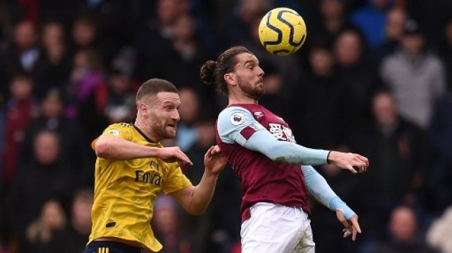 Bek Arsenal Shkodran Mustafi berebut bola dengan striker Burnley Jay Rodriguez (kanan) dalam laga Liga Inggris di Turf Moor. Oli SCARFF / AFP