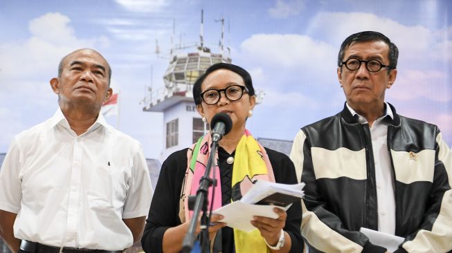 Menteri Luar Negeri Retno Marsudi (tengah) didampingi Menko PMK Muhadjir Effendy (kiri) dan Menteri Hukum dan HAM Yasonna Laoly (kanan) memberikan keterangan pers seusai menggelar rapat terbatas dengan Presiden Joko Widodo di Lanud Halim Perdanakusuma, Jakarta, Minggu (2/2). [ANTARA FOTO/Hafidz Mubarak A]