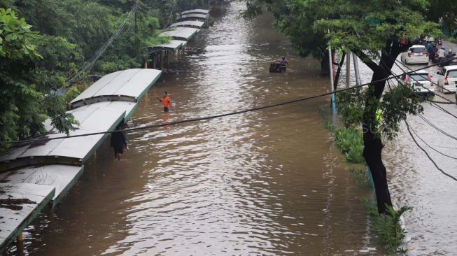 Banjir merendam Jalan Cempaka Putih, Jakarta Pusat, Sabtu (08/02). [Suara.com/Alfian Winanto]