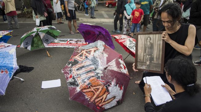 Seniman melakukan aksi teaterikal saat peringatan Bulan Cinta Ibu Bangsa Inggit Garnasih di Bandung, Jawa Barat, Minggu (9/2). [ANTARA FOTO/M Agung Rajasa]