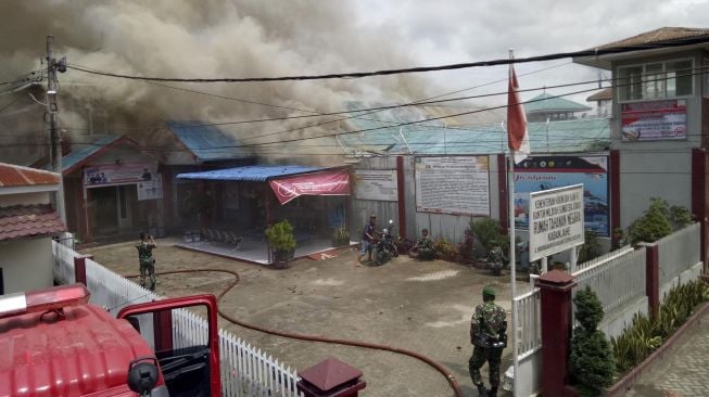 Petugas gabungan berusaha memadamkan api yang membakar gedung saat terjadi kerusuhan di Rumah Tahanan Negara (Rutan) Kelas II B Kabanjahe, Kabupaten Karo, Sumatera Utara, Rabu (12/2). [ANTARA FOTO/Hasan]