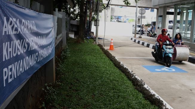 Disabilitas menaiki kendaraan khusus saat peresmian area parkir khusus kendaraan penyandang disabilitas di Stasiun MRT Lebak Bulus, Jakarta, Kamis (20/2).  [Suara.com/Angga Budhiyanto]