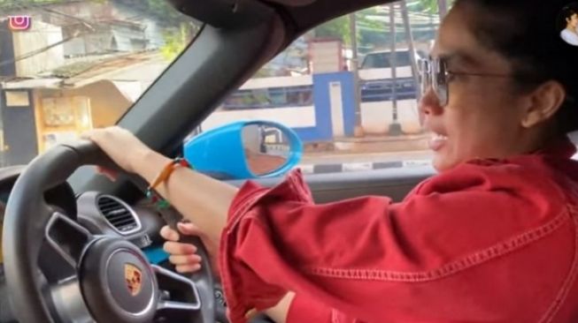 Ussy Sulistiawaty mengemudikan Porsche Boxter [scrrenshot: YouTube Ussy Andhika Official].