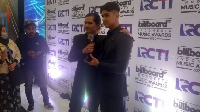 Al Ghazali dan Dul Jaelani menerima penghargaan untuk Dewa 19 di ajang Billboard Indonesia Music Awards 2020, Rabu (26/2/20202). [Ismail/Suara.com]