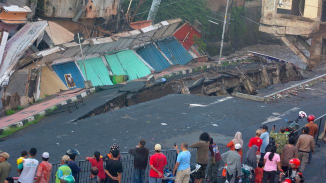 Sejumlah warga melihat pertokoan Jompo yang ambruk di Jalan Sultan Agung Jember, Jawa Timur, Senin (2/3). [ANTARA FOTO/Seno]
