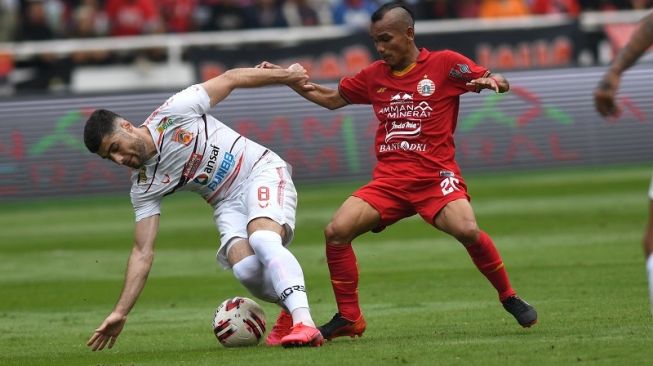 Winger Persija Jakarta, Riko Simanjuntak (kanan) berebut bola dengan pemain Borneo FC, Muriddin Davronov dalam pertandingan pekan pertama Liga 1 2020 di Stadion Utama Gelora Bung Karno (SUGBK), Jakarta, Minggu (1/3/2020). [ANTARA FOTO/Aditya Pradana Putra]