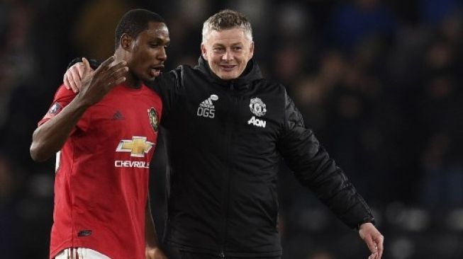 Manajer Manchester United Ole Gunnar Solskjaer (kanan) berbicara dengan Odion Ighalo usai skuatnya mengalahkan Derby County dalam lanjutan Piala FA di Pride Park Stadium. Oli SCARFF / AFP