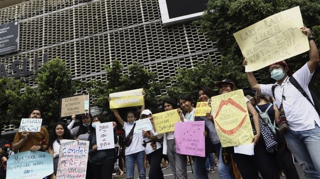 Sejumlah massa yang tergabung dalam Aliansi Gerakan Perempuan Anti-Kekerasan (GERAK Perempuan) membawa poster saat melakukan aksi unjuk rasa di depan kantor Bawaslu, Jakarta, Minggu (8/3). [Suara.com/Angga Budhiyanto]