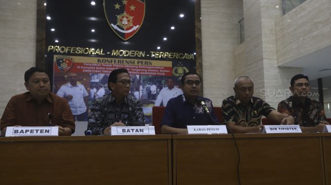 Kepala Bagian Penerangan Umum Divisi Humas Polri Kombes Pol Asep Adi Saputra (tengah) didampingi Direktur Tindak Pidana Tertentu Bareskrim Brigjen Pol Mohamad Agung Budijono (kedua kanan), Kepala Biro Humas Batan Heru Umbara (kedua kiri) serta Kepala Biro Hukum, Kerjasama dan Komunikasi Publik Bapeten Indra Gunawan memberi keterangan pers terkait Penyidikan Tindak Pidana di Bidang Ketenaganukliran di Gedung Bareskrim Polri Jakarta, Jumat (13/3). [Suara.com/Angga Budhiyanto]