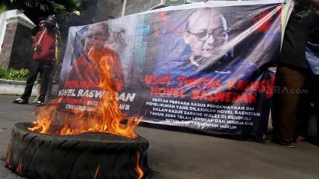 Puluhan massa yang tergabung dalam aliansi corong rakyat melakukan aksi demontrasi membakar ban di Kejaksaan Agung, Jakarta, Jumat (13/3). [Suara.com/Oke Atmaja]