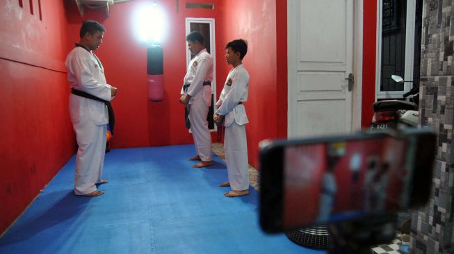 Pelatih mengajarkan muridnya latihan taekwondo di Perumahan Graha Arradea, Ciherang, Kabupaten Bogor, Jawa Barat, Minggu (29/3). [ANTARA FOTO/Arif Firmansyah]