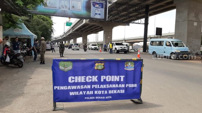 PSBB Hari Kedua Bekasi: Petugas Bagikan Masker untuk Pemotor Lalai