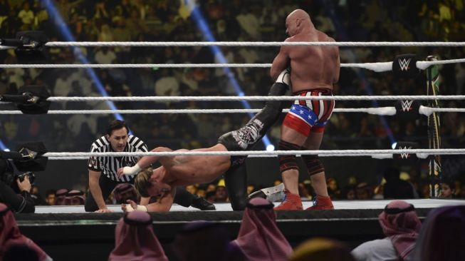 Kurt Angle (kanan) mengunci kaki lawannya, Dolph Ziggler, dalam perempat final WWE World Cup di King Saud University Stadium, Riyadh, Arab Saudi, 2 November 2018. [AFP/Fayez Nureldine]