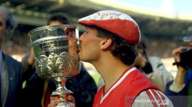 Kenny Sansom dari Arsenal mencium trofi saat merayakan kemenangan dalam final Littlewoods Cup melawan Liverpool di Stadion Wembley pada 5 April 1987. (Antara/Action Images)