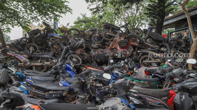 Ratusan sepeda motor bertumpuk di tempat penampungan di Jalan Pejuang, Teluk Pucung, Bekasi Utara, Jawa Barat, Selasa (19/5). [Suara.com/Alfian Winanto]