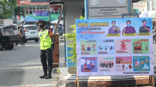 Personel kepolisian berjaga di pintu masuk Pasar Sudimampir di Banjarmasin, Kalimantan Selatan, Senin (1/6).  [ANTARA FOTO/Bayu Pratama]
