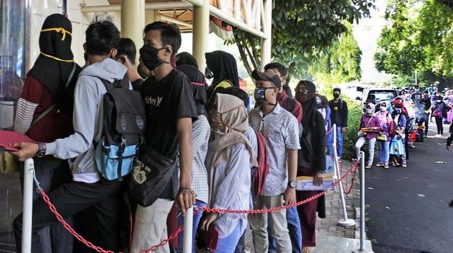 Sejumlah warga antre untuk mengurus pembuatan Kartu Pencari Kerja (Kartu Kuning) di Kantor Dinas Tenaga Kerja Kota Serang, Banten, Selasa (9/6/2020).  [ANTARA FOTO/Asep Fathulrahman]