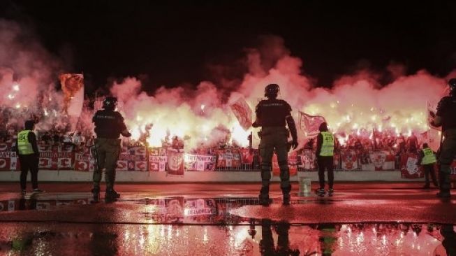 Para pendukung Partizan bersorak sorai saat semifinal Piala Serbian melawan tim sekota Red Star Belgrade di Stadion Partizan, Belgrade, pada 10 Juni 2020. (AFP/OLIVER BUNIC) 