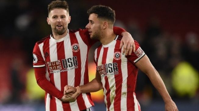 Gelandang Sheffield United Oliver Norwood (kiri) bersama rekan setimnya George Baldock saat menghadap West Ham United. Oli SCARFF / AFP