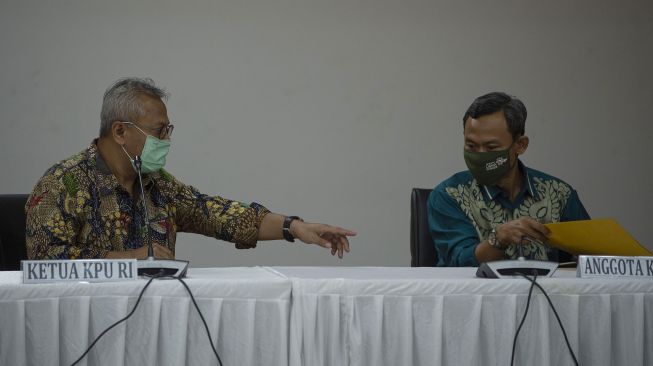 Ketua KPU Arief Budiman (kiri) berbicara dengan Komisioner KPU Pramono Ubaid Tanthowi di sela konferensi pers tentang Pilkada serentak di Gedung KPU, Jakarta, Jumat (12/6/). [ANTARA FOTO/Aditya Pradana Putra]