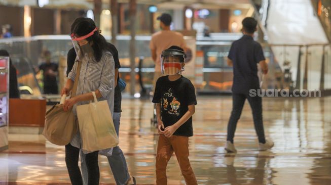 Pengunjung mengenakan face shield saat berbelanja di Pondok Indah Mall, Jakarta Selatan, Senin (15/6). [Suara.com/Alfian Winanto]