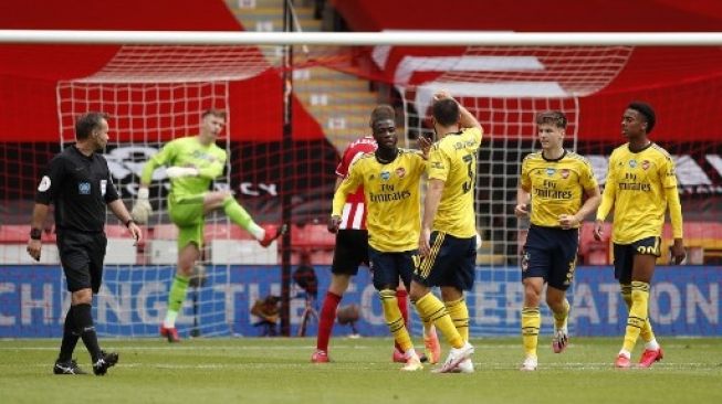 Pemain Arsenal Nicolas Pepe merayakan golnya dari titik penalti ke gawang Sheffield United saat laga perempat final Piala FA di Bramall Lane. ANDREW BOYERS / POOL / AFP