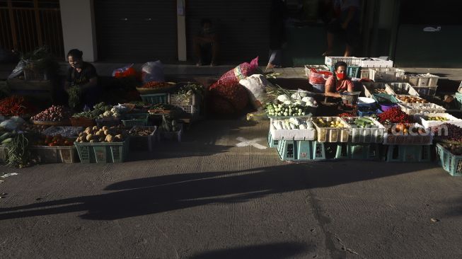 Pedagang menunggu pembeli di Pasar Perumnas Klender, Jakarta, Selasa (16/6). [Suara.com/Angga Budhiyanto]