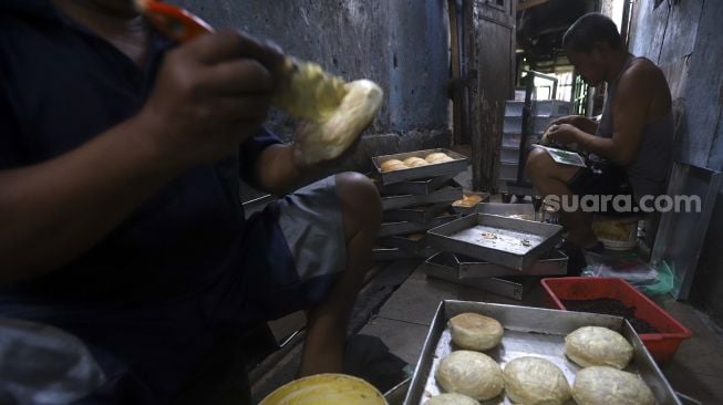 Aktivitas pekerja menyelesaikan pembuatan roti skala rumahan di kawasan Bendungan Hilir, Jakarta, Jumat (3/7). [Suara.com/Angga Budhiyanto]