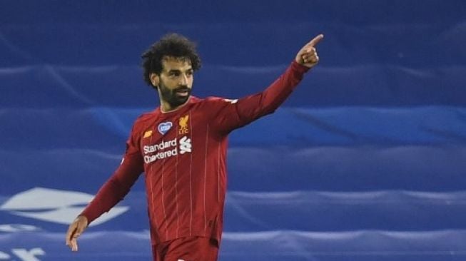 Pemain Liverpool Mohamed Salah merayakan golnya ke gawang Brighton and Hove Albion dalam lanjutan Liga Inggris di American Express Community Stadium, Brighton. DANIEL LEAL-OLIVAS / POOL / AFP