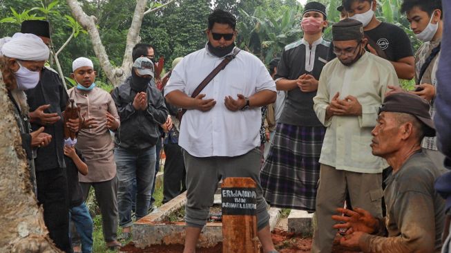 Keluarga berdoa dipusara pusara almarhum pencipta lagu anak-anak, Papa T Bob di TPBU Jurang Mangu, Pondok Ranji, Tangerang Selatan, Jumat (10/7). [Suara.com/Alfian Winanto]