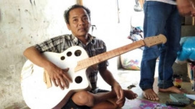 Yono dan gitar buatannya. [Foto: Ayotasik.com]