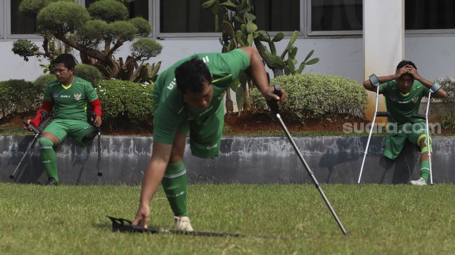 Sejumlah pemain Timnas Garuda INAF (Indonesia Amputee Football) beristirahat di sela-sela sesi latihan di lapangan Rumah Sakit Suyoto, Bintaro, Jakarta, Sabtu (18/7/2020). [Suara.com/Angga Budhiyanto]