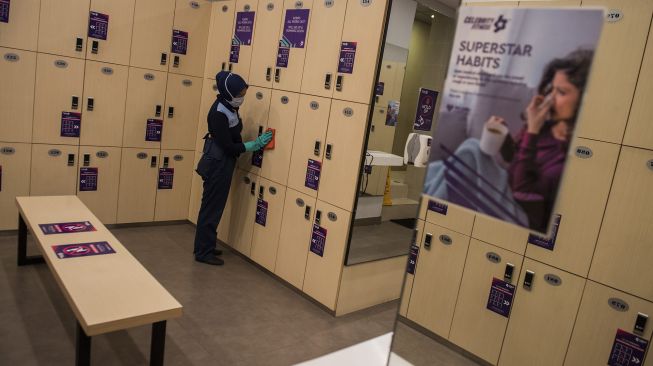 Petugas membersihkan lemari kecil berkunci (locker) saat simulasi pembukaan dan peninjauan tempat kebugaran di Celebrity Fitness, Bandung, Jawa Barat, Kamis (23/7/2020). [ ANTARA FOTO/M Agung Rajasa]
