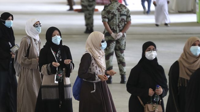 Sejumlah jemaah haji tiba untuk melangsungkan lontar jumrah dengan mengenakan masker wajah untuk menghindari penularan COVID-19 di Mina, Arab Saudi, Sabtu (1/8/2020). [AFP]