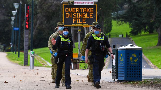 Petugas kepolisian dan tentara melakukan patroli di Melbourne, Australia, Selasa (4/8).  [AFP/William WEST]