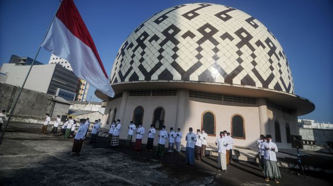 Sejumlah pengurus Dewan Kemakmuran Masjid (DKM) mengikuti upacara peringatan kemerdekaan Republik Indonesia di atap Masjid Raya Bandung, Jawa Barat, Senin (17/8/2020).  [ANTARA FOTO/Raisan Al Farisi]
