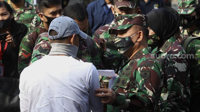 Panglima Kodam Jaya, Mayjen TNI Dudung Abdurachman (ketiga kanan) memberikan ganti rugi kepada warga sipil yang menjadi korban penyerangan Mapolsek Ciracas di Koramil 05 Kramat Jati, Jakarta, Rabu (2/9/2020). [Suara.com/Angga Budhiyanto] 