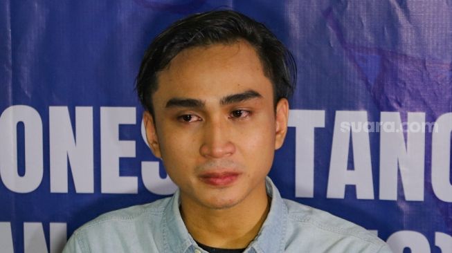 Artis Lutfi Agizal menangis ketika memberikan pernyataan pada awak media saat menggelar konferensi pers di kantor Komnas Perlindungan Anak, Pasar Rebo, Jakarta Timur, Minggu (6/9). [Suara.com/Alfian Winanto]