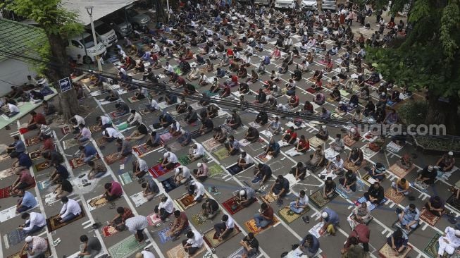 Sejumlah umat Muslim mendengarkan khotbah saat melaksanakan ibadah Shalat Jumat secara berjamaah di lingkungan Masjid Cut Meutia, Jakarta, Jumat (11/9/2020). [Suara.com/Angga Budhiyanto]