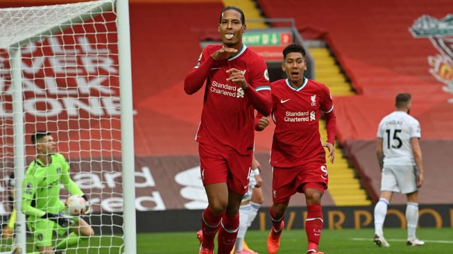 Bek Liverpool Van Dijk merayakan golnya usai mencetak gol kedua timnya selama pertandingan sepak bola Liga Premier Inggris antara Liverpool melawan Leeds United di Anfield, Liverpool, Inggris, Mingggu (13/9).  [Paul ELLIS / POOL / AFP]