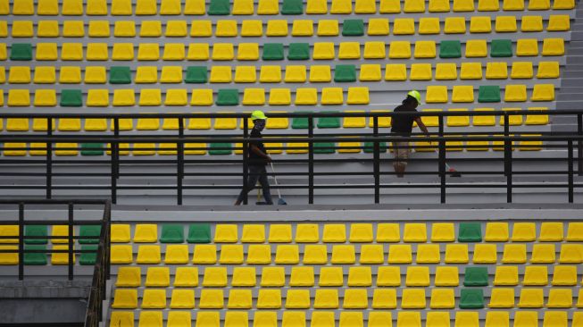 Pekerja membersihkan bagian tribun penonton di Stadion Gelora Bung Tomo (GBT), Surabaya, Jawa Timur, Jumat (18/9/2020).  [ANTARA FOTO/Moch Asim]